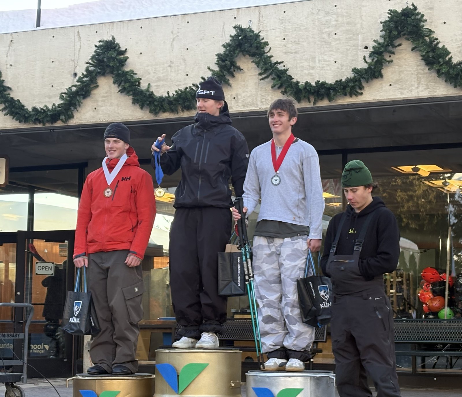 Canyon and fellow athletes on the medal stands wearing their medals and holding prize bags after a freeride competition