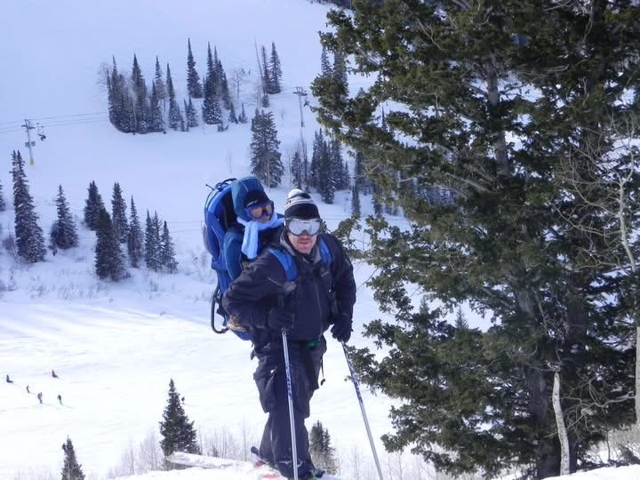 Canyon as a toddler riding in a ski carrier pack on an adult's back